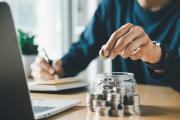 Wall Mural - Man hands putting coins stack, Concept business finance saving money and investment.