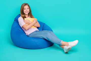 Poster - Full length photo of dreamy sweet girl dressed pink t-shirt bean bag cuddling book empty space isolated teal color background