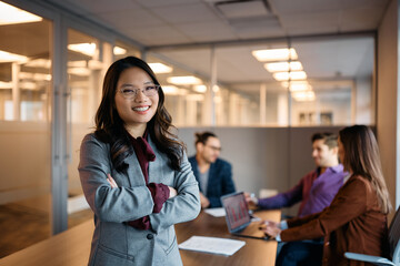 Wall Mural - Confident female business leader during meeting in office looking at camera.