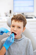 © nata_zhekova - Kid in a dental clinic. Orthodontic treatment. Children's dentistry, Pediatric Dentistry. A boy in braces on his teeth at a dentist's appointment.