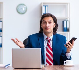 Young male businessman working in the office