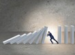 © Elnur - Businessman preventing domino effect in business concept