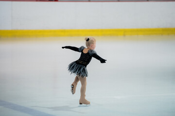 Wall Mural - Figure skating of a little 4 year old girl. First competition. Excitement, pride.