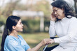 © NanSan - Young asian care helper with asia elderly woman on wheelchair relax together park outdoors to help and encourage and rest your mind with green nature.