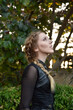 © faestock - Close up portrait of beautiful female model with blonde plait, wearing black leather catsuit, fantasy assassin warrior.  Posing in forest  tree background