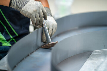 Wall Mural - Steel handles are welded with argon-arc welding. Man wearing argon-arc welding gloves Industrial welder welding with argon machine.