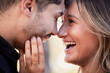 © Nadia L/peopleimages.com - Couple, forehead touch and laugh together with happiness, comic moment or romance outdoor for date. Man, woman and funny time with love, care or happy in nature closeup with hand, face and crazy joke