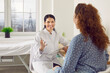 © Studio Romantic - Friendly positive doctor at modern clinic giving professional medical consultation to patient. Happy smiling female physician talking to young woman, holding clipboard and writing down her answers