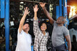 © feeling lucky - Group of multiethnic man and woman technician engineer or worker standing and raising hands celebrate successful together or completed deal commitment at heavy industry manufacturing factory