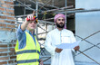 © Jack Tamrong - Engineer Construction man showing project to arab investor man in construction site