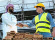 © Jack Tamrong - Engineer Construction man shaking hand with Arab businessman in construction site