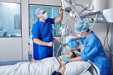 Wall Mural - Nurse and doctor using medical ventilator on female patient while cardiopulmonary resuscitation in ICU and monitoring health. CPR in ICU