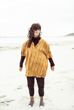Natural Girl Stands On Windy Remote Beach With Oversized Shirt