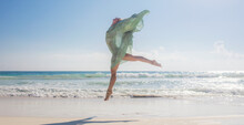 Woman Jumping On Beach Like A Bird