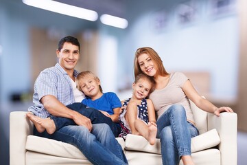 Happy young family with children on a sofa