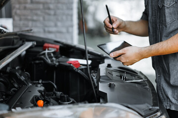 Wall Mural - Auto mechanic working in garage. Repair service.
