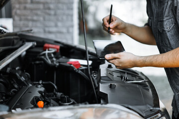 Wall Mural - Auto mechanic working in garage. Repair service.
