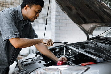 Wall Mural - Auto mechanic working in garage. Repair service.
