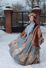 Beautiful Russian Woman In A Blue Vintage Dress. Russian Village. Winter.