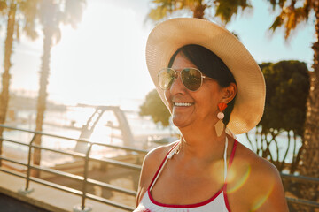 Canvas Print - Travel, peace and senior woman at the beach for summer, walk and weekend fun in Bali. Sun, smile and elderly person on holiday at the sea to relax during the start of retirement by the ocean