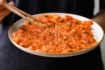 Wall Mural - Kimchi pancake (Kimchi jeon or kimchi buchimgae) with hand ready to eating, Korean food