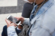 © moose/peopleimages.com - Woman, smartphone screen and earphones in city for social media, radio technology and iot internet. Female hands in street listening to music with cellphone mockup, connection and mobile podcast app