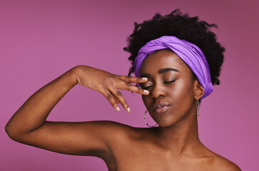 Poster - Face, beauty and skincare with a model black woman on a pink background in studio for natural care. Hand, hair and headband with an attractive young female posing to promote cosmetic treatment