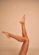 © gpointstudio - Legs up of unrecognizable woman in studio shot