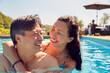 Loving Mature Couple Hugging In Swimming Pool On Summer Vacation 