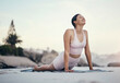 © Nicholas F/peopleimages.com - Stretching, yoga and woman on a beach floor for wellness, peace and zen, pose and balance on sky background. Meditation, stretch and girl relax with training, energy and peaceful, mindset or workout
