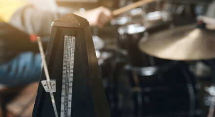 Wall Mural - Man playing on drums and bronze cymbal plates with drumsticks in recording studio. Musician during percussion musical instrument perfomance indoors