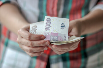 Woman counting czech crown banknotes