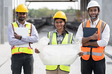 India engineer woman holding paper work with team engineer man at precast site work