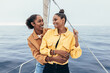 © ADDICTIVE STOCK - Positive black girlfriends on yacht
