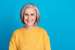 Photo portrait of stunning grandma toothy beaming smile promoter dentist wear trendy yellow garment isolated on blue color background