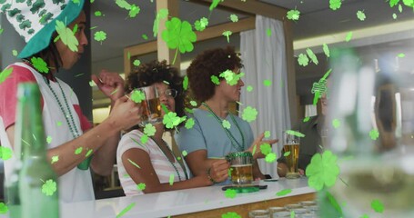 Wall Mural - Animation of clover icons over diverse friends drinking beer