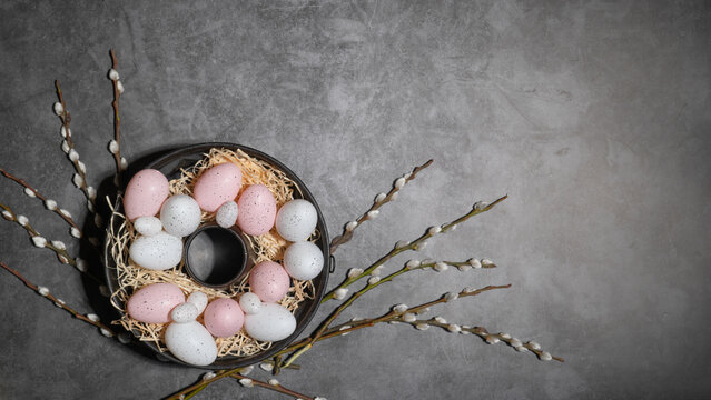 Fototapete - HAPPY EASTER holiday celebration backgroud greeting card - Easter nests with pink and white easter quail eggs and catkins on concrete table texture, top view