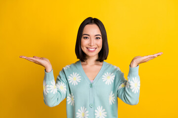 Photo of glad pretty lovely lady wear trendy clothes arm compare two variants demonstrate empty space isolated on yellow color background