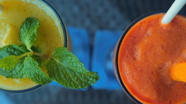 papaya and mango smoothies with mint leaf on restaurant table