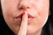 © Thunderstock - Close-up of shush gesture with finger over mouth made by woman