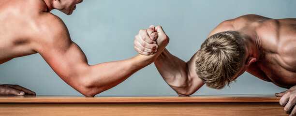 Wall Mural - Hands or arms of man. Arm wrestling. Two men arm wrestling. Rivalry, closeup of male arm wrestling