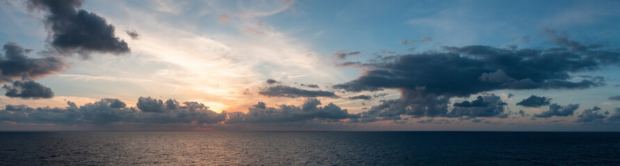Wall Mural - Dramatic Colorful Sunset Sky over Mediterranean Sea. Clouds with Sunrays. Cloudscape Nature Background. Panorama