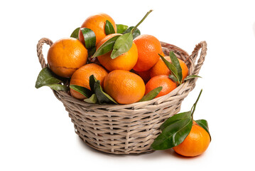 Wall Mural - Basket with tangerines and green leaves