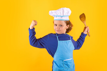 Kid cook with cooking ladle. Chef kid boy making healthy food. Portrait of little child in chef hat isolated on studio background. Child chef. Cooking process.