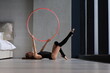 Little girl doing exercise with hoop on floor