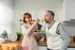 © Kawee - Caucasian senior elderly couple spend time together in kitchen at home