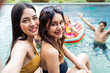 © Kawee - Asian women friend in bikini use mobile phone taking a photo at a pool
