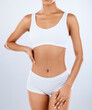 © Clayton D/peopleimages.com - Fitness, black woman and body with healthy lifestyle, bikini and workout on grey studio background. Exercise, female athlete or lady in underwear, training or nutrition with diet, sports and backdrop
