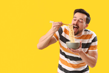 Poster - Handsome man with bowl of Chinese noodles on yellow background