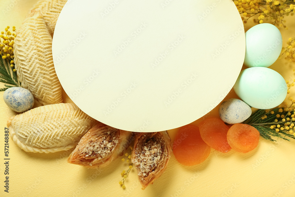 Blank card with flowers, eggs and treats on yellow background. Novruz Bayram celebration